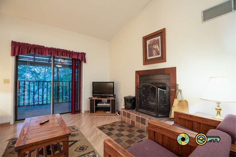 Living Room With Furniture, Fireplace, And TV