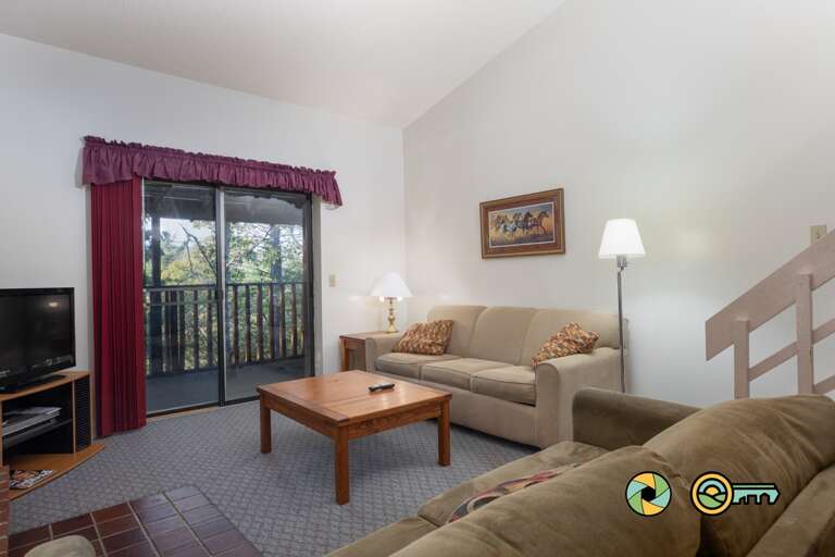 Living Room Interior With Sofas, Coffee Table, And Balcony Door