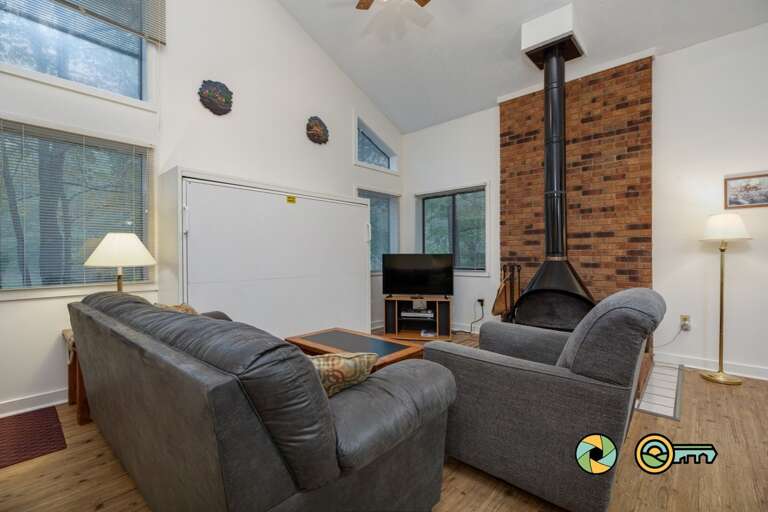 Living Room With Sofas, Fireplace, And Television