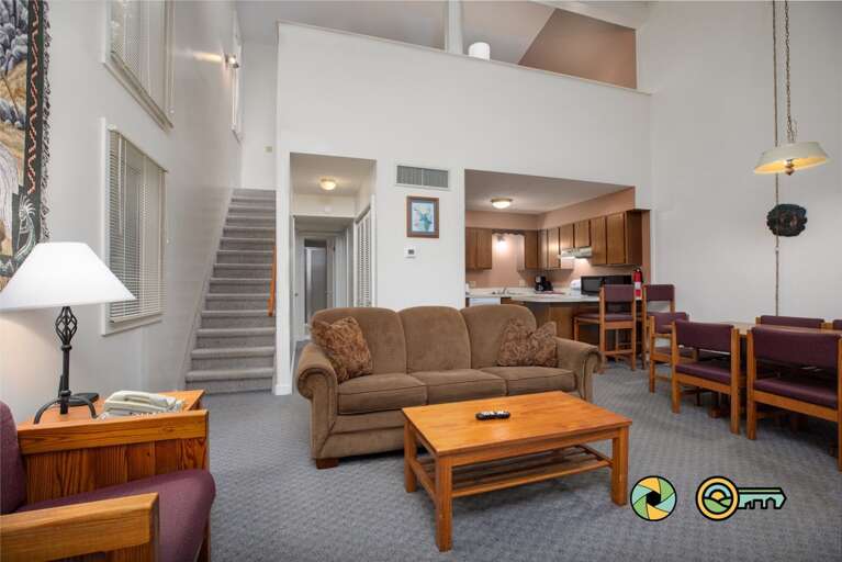 Interior Of Vacation Rental Living Room With Staircase And Kitchenette