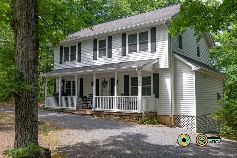 Two-story Residential Building With Porch And Trees Two-story Residential Building With Porch And Trees