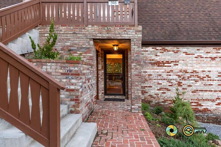 Brick Building Entrance With Wooden Stairs And Lit Doorway Brick Building Entrance With Wooden Stairs And Lit Doorway