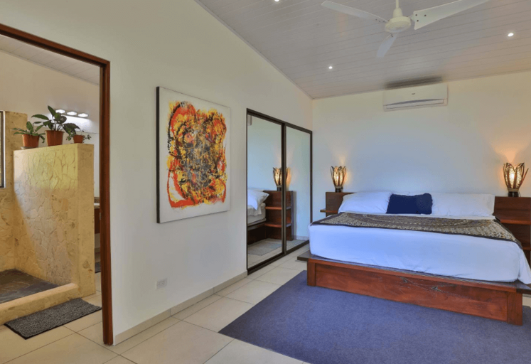 Modern Room With Large Bed And Artwork