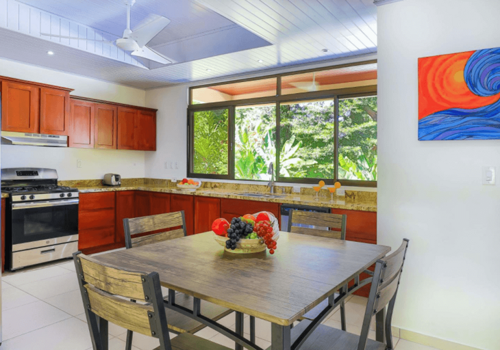 Modern Kitchen Interior With Wooden Table And Artwork