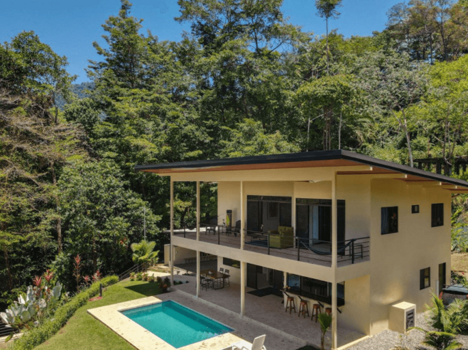 Two-story Residential Building With Pool Surrounded By Trees