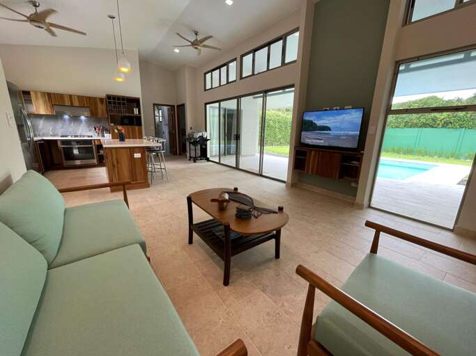 Interior Living Space With Kitchen And View Of Pool Interior Living Space With Kitchen And View Of Pool