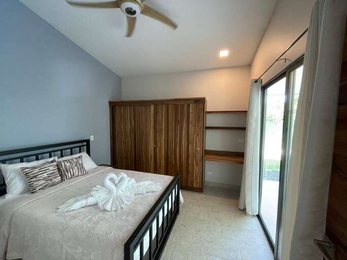 Bedroom With Bed, Wardrobe, And Sliding Doors Bedroom With Bed, Wardrobe, And Sliding Doors