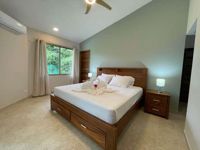 Bedroom With Large Bed, Ceiling Fan, And Window Bedroom With Large Bed, Ceiling Fan, And Window