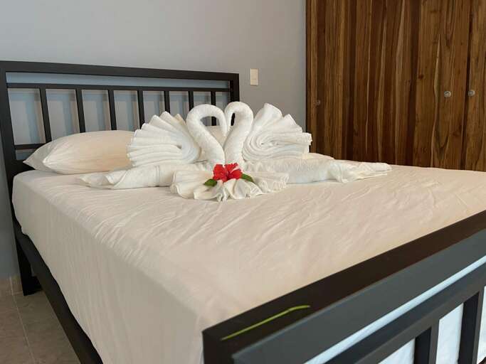 Bed With Swan-shaped Towels And Red Flower Bed With Swan-shaped Towels And Red Flower