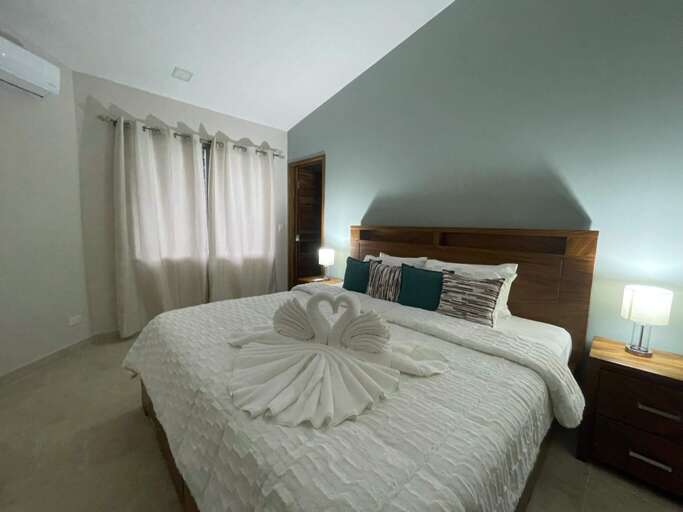 Bedroom With Neatly Folded Towels On Bed Bedroom With Neatly Folded Towels On Bed