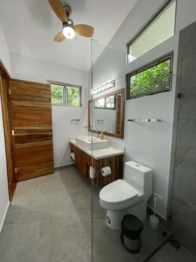 Modern Bathroom With Glass Shower And Wooden Accents Modern Bathroom With Glass Shower And Wooden Accents