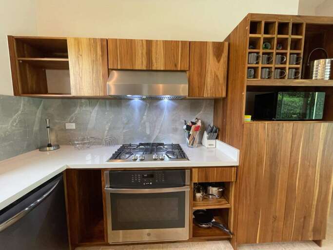 Modern Kitchen With Wooden Cabinets And Stainless Steel Appliances Modern Kitchen With Wooden Cabinets And Stainless Steel Appliances