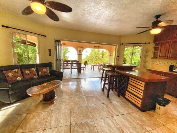 Interior Living Space With Open Plan Kitchen, Dining Area, And Ceiling Fans