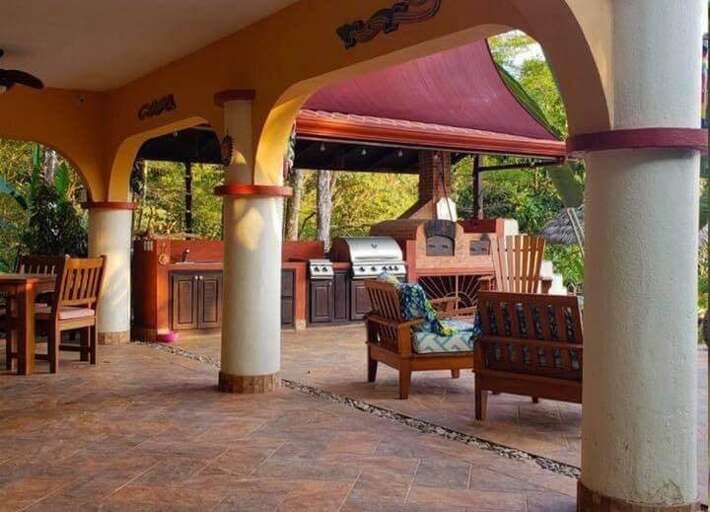 Outdoor Patio Area With Chairs And Barbecue Grill