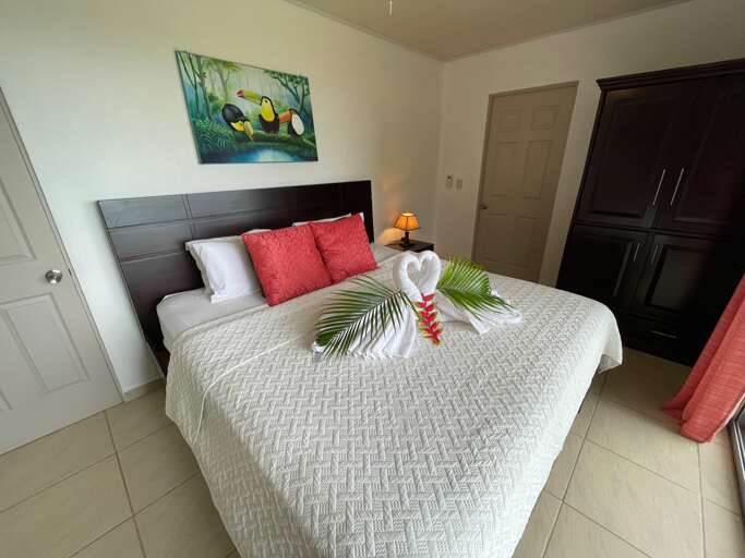 Bedroom With Made Bed And Decorative Towel Swans Bedroom With Made Bed And Decorative Towel Swans