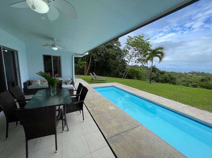 Patio With Dining Area And Adjacent Swimming Pool Overlooking Green Landscape Patio With Dining Area And Adjacent Swimming Pool Overlooking Green Landscape