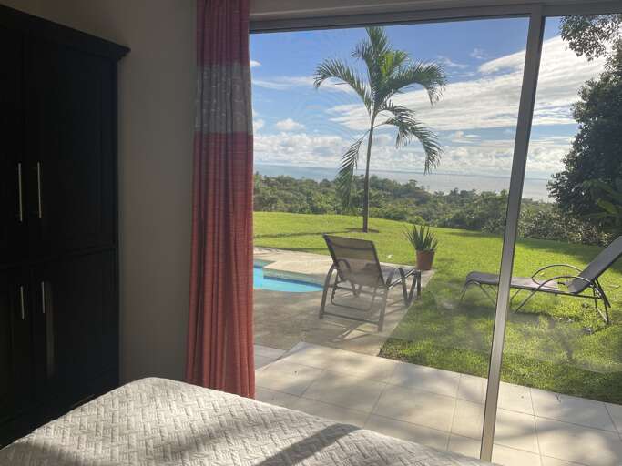 Room Interior With View Of Pool And Palm Trees Through Glass Door Room Interior With View Of Pool And Palm Trees Through Glass Door