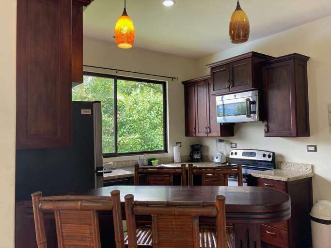 Interior Of A Kitchen With Wooden Cabinets And Dining Table