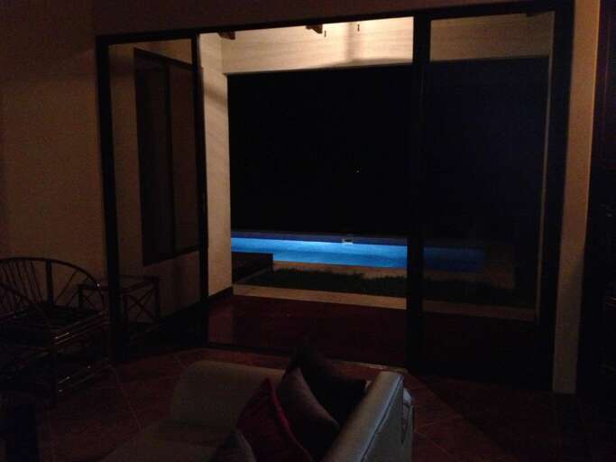 Room Interior At Night With Sofa And View Of The Sea Through Balcony Door