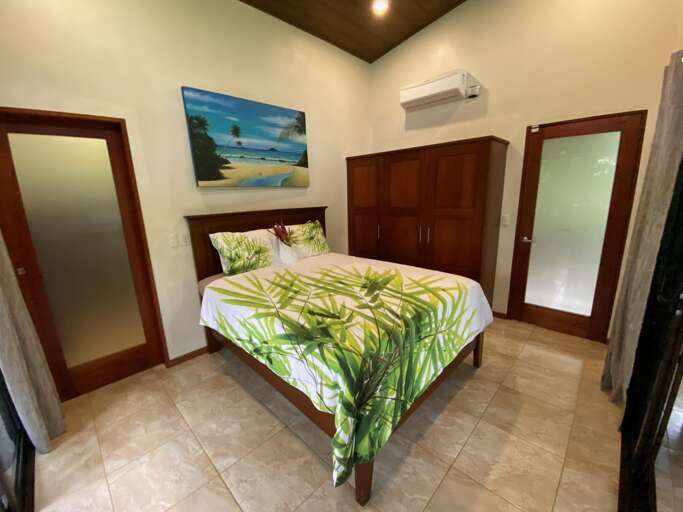 Bedroom With Bed, Beach Picture, And Wooden Furniture Bedroom With Bed, Beach Picture, And Wooden Furniture