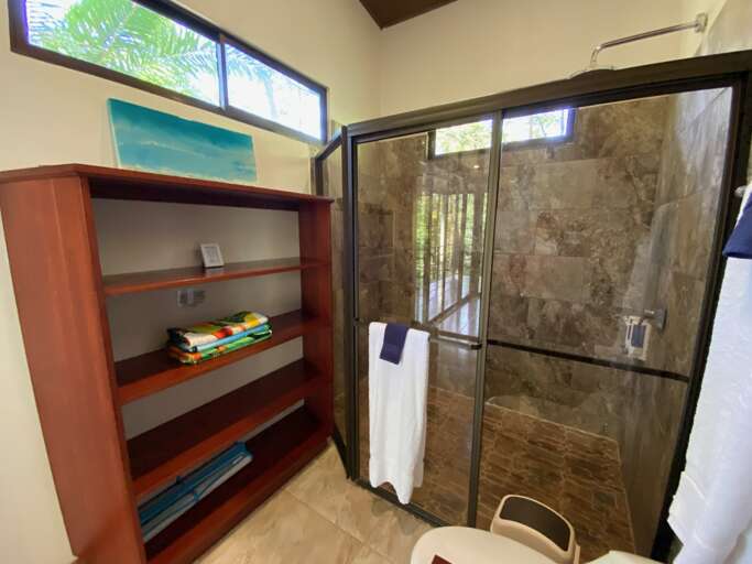 Modern Bathroom With Glass Shower And Shelf With Towels Modern Bathroom With Glass Shower And Shelf With Towels