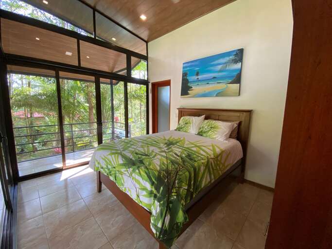 Interior Of A Modern Bedroom With Large Windows And Artwork Interior Of A Modern Bedroom With Large Windows And Artwork
