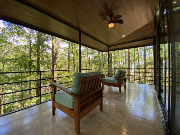 Enclosed Balcony With Chairs Overlooking Forest Enclosed Balcony With Chairs Overlooking Forest