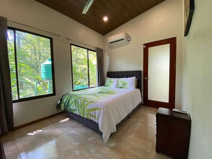 Bedroom With Large Bed, Windows, And Air Conditioner Bedroom With Large Bed, Windows, And Air Conditioner