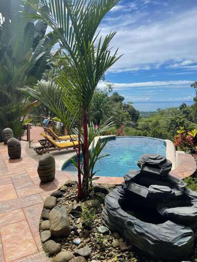 Tropical Poolside View With Sea In The Distance Tropical Poolside View With Sea In The Distance