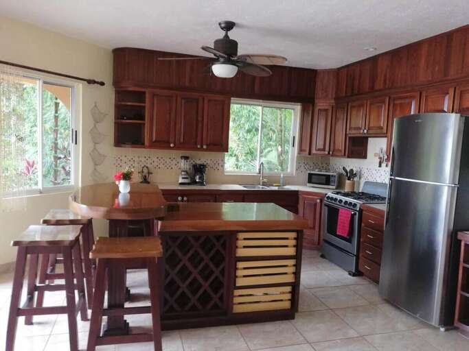 Residential Kitchen Interior With Wooden Cabinets And Modern Appliances Residential Kitchen Interior With Wooden Cabinets And Modern Appliances