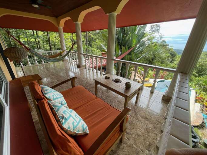 Tropical Balcony View With Seating And A Hammock Overlooking The Sea Tropical Balcony View With Seating And A Hammock Overlooking The Sea