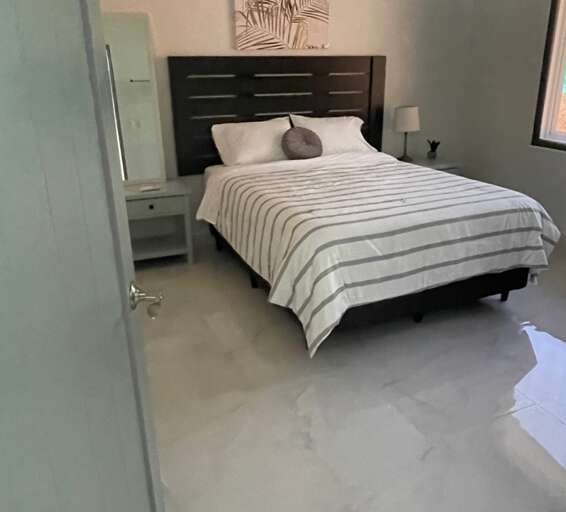 Modern Bedroom With Striped Bedding And Abstract Wall Art