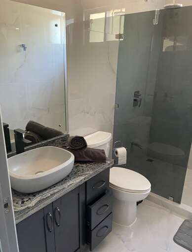 Modern Bathroom Interior With Shower Cabin And Vanity