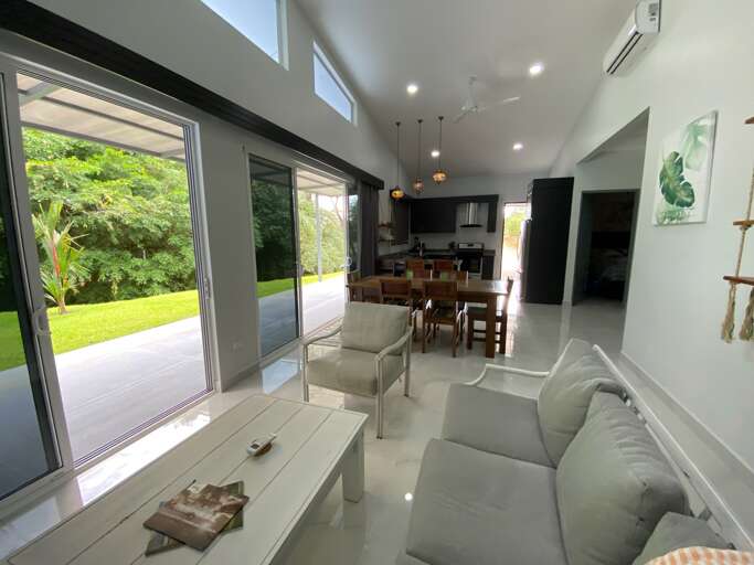Modern Living Room With Sliding Doors Open To Garden