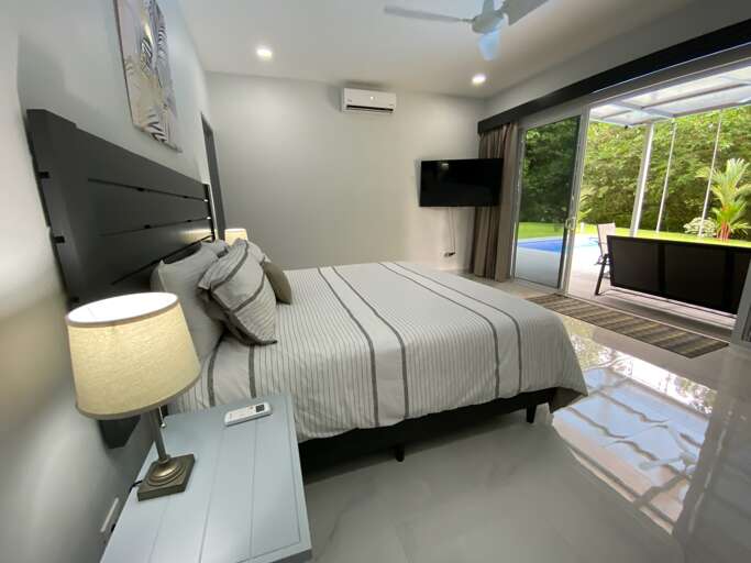 Modern Bedroom Interior With Sliding Glass Door Leading To Outdoor Area