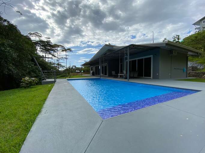 House With Swimming Pool Under Cloudy Sky