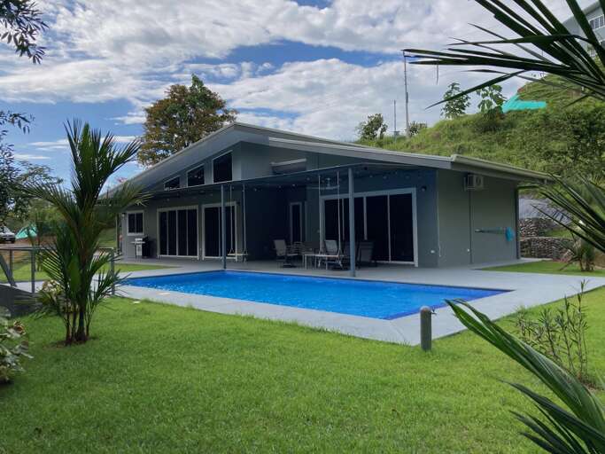 House With Swimming Pool And Green Lawn