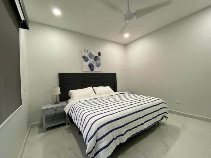 Modern Bedroom With Striped Bedding And Wall Art