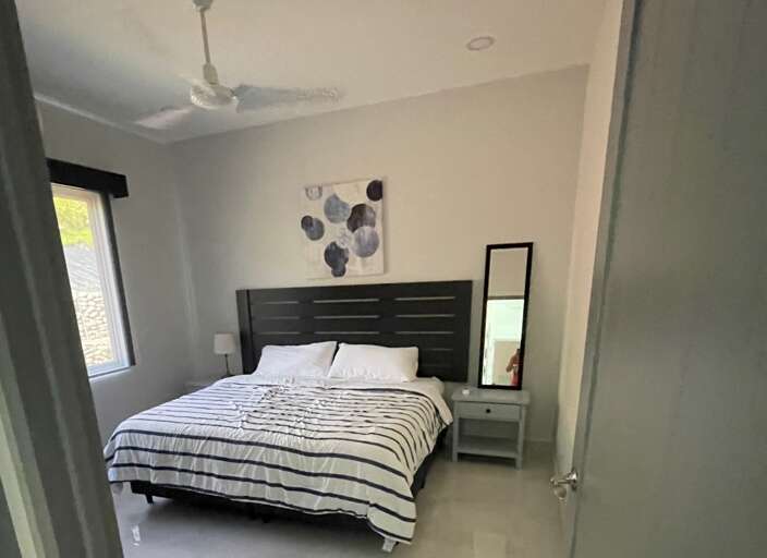 Modern Bedroom With Striped Bedding And Wall Art