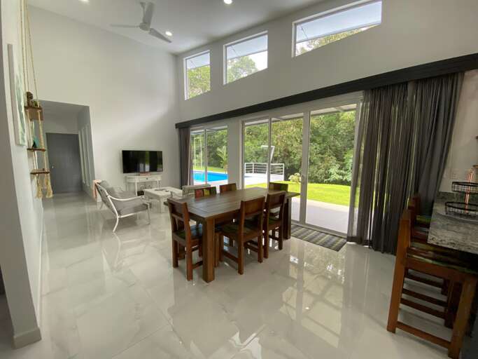 Modern Living Room With Dining Area And View Of Pool
