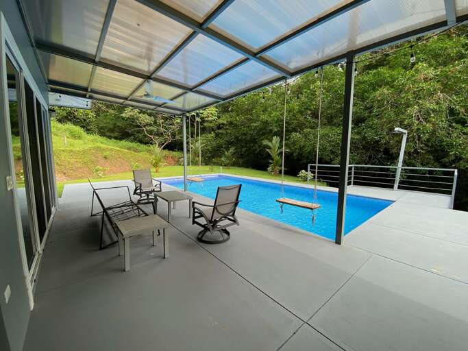 Swimming Pool With Chairs On A Patio