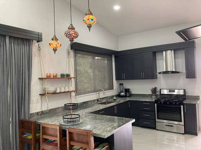 Modern Kitchen Interior With Island And Pendant Lights