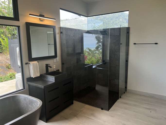 Modern Bathroom With Glass Shower And View Of Nature