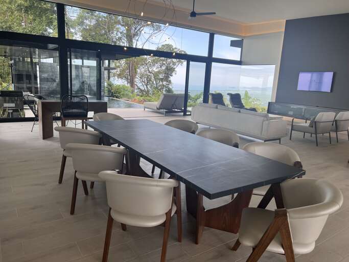 Modern Dining Room With Large Table And Ocean View