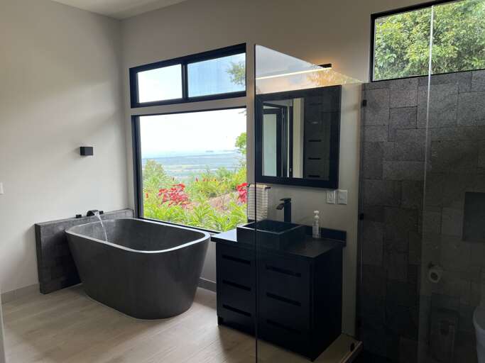 Modern Bathroom With Freestanding Tub And Ocean View