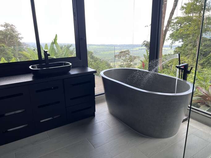 Bathroom With Freestanding Tub And Scenic View Through Large Windows