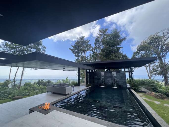 Modern Poolside Area With Firepit And Ocean View