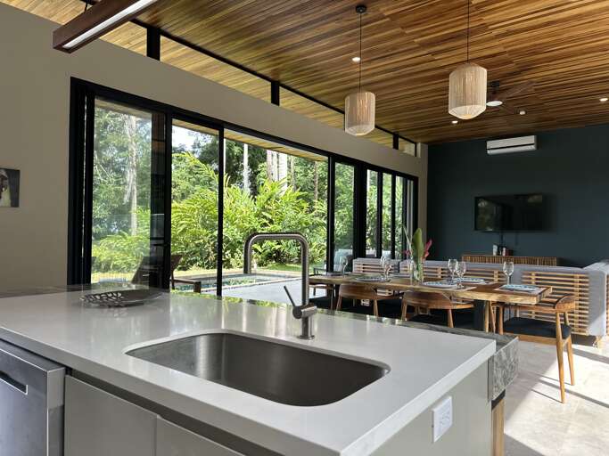 Modern Kitchen And Dining Area With Garden View Modern Kitchen And Dining Area With Garden View