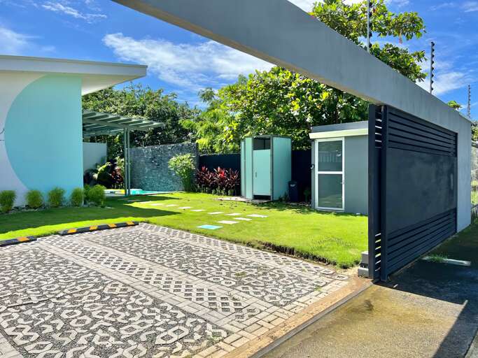 Modern Residential Entrance With Driveway And Landscaped Garden