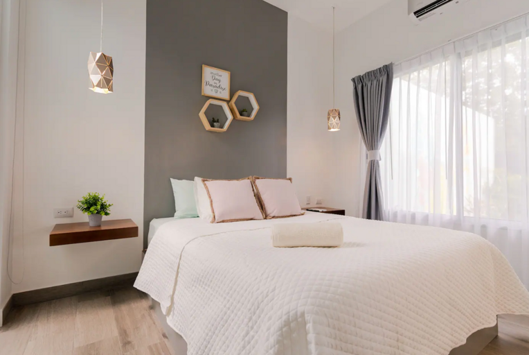 Modern Bedroom Interior With White Bed And Decorative Wall Elements